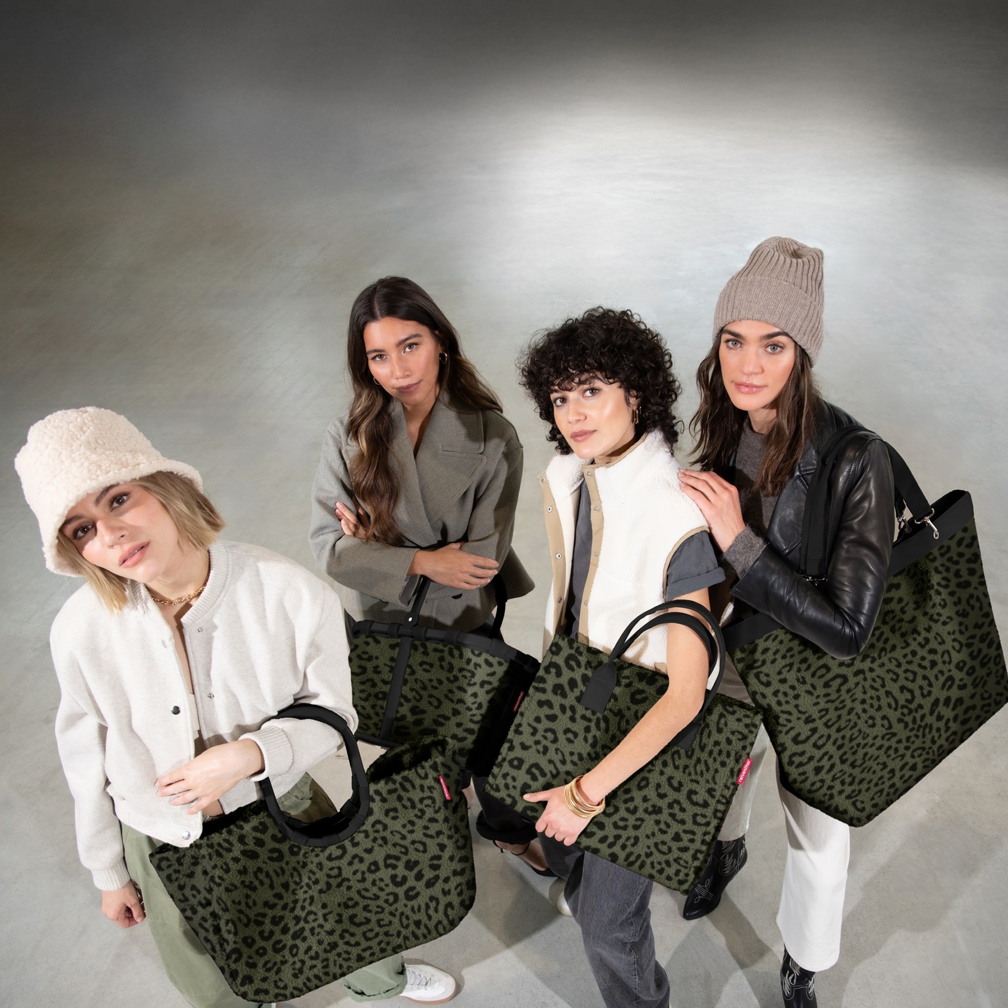 Four women with green leopard bags and stylish autumn outfit