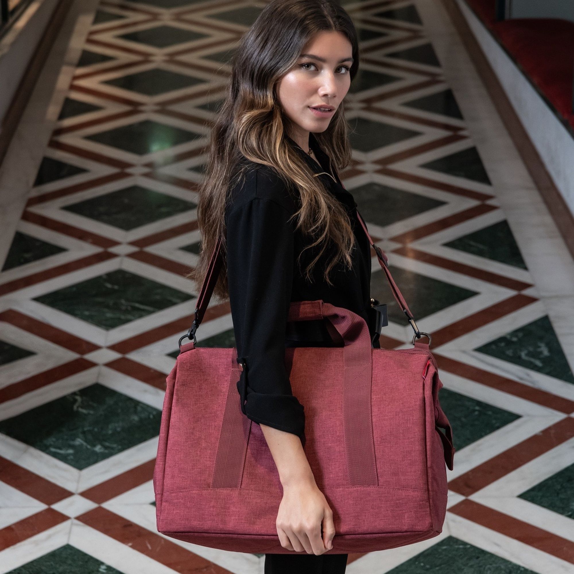 Woman carrying elegant red shoulder bag