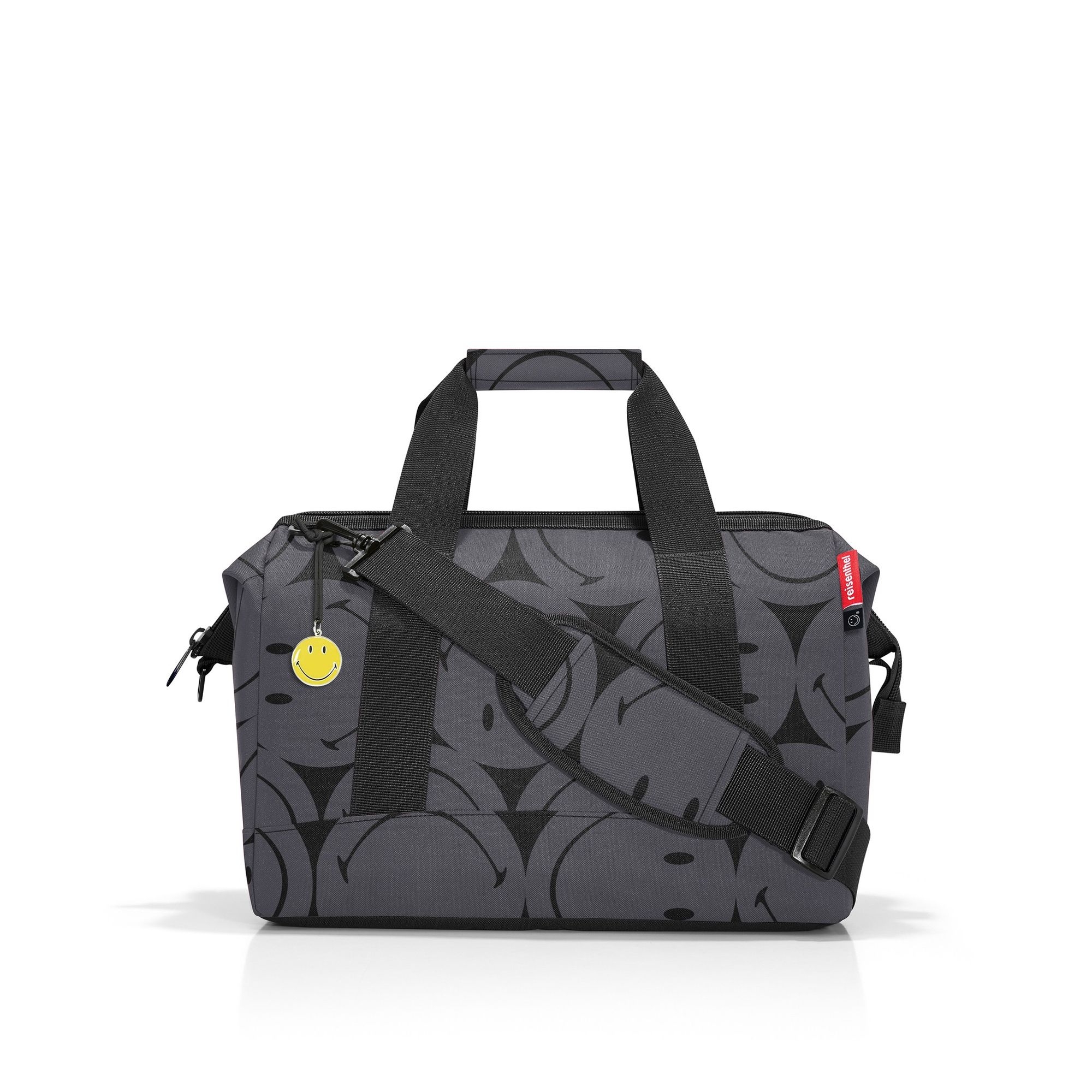 Grey travel bag with black smileys and shoulder strap