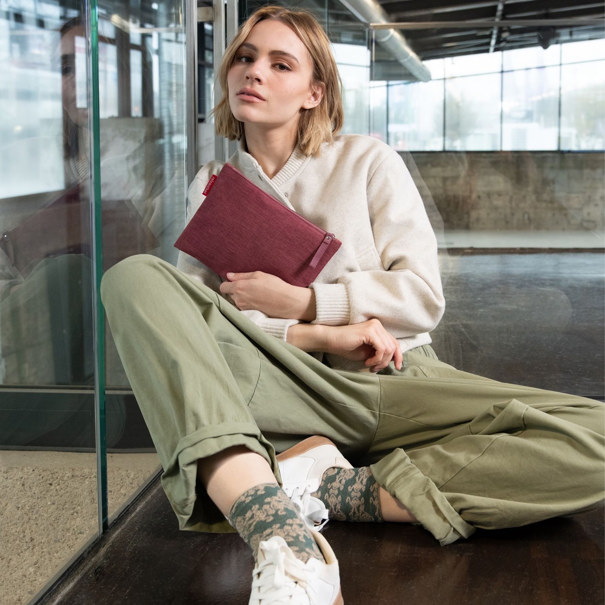 Woman with red fabric pouch, casual streetwear outfit