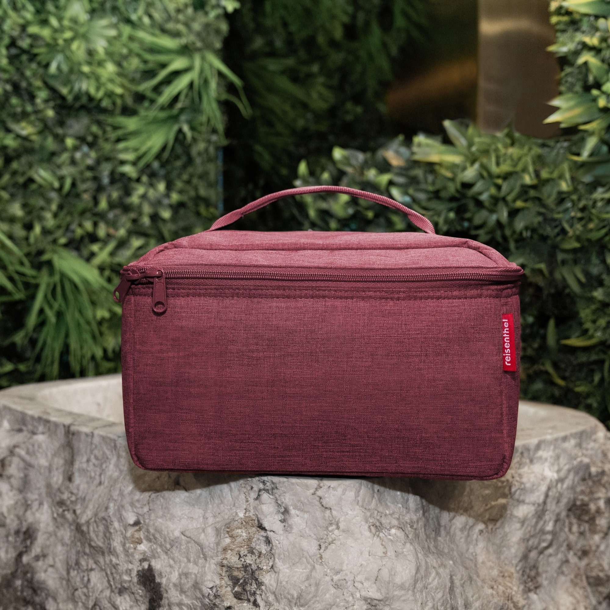 Red travel toiletry bag with handle and zipper