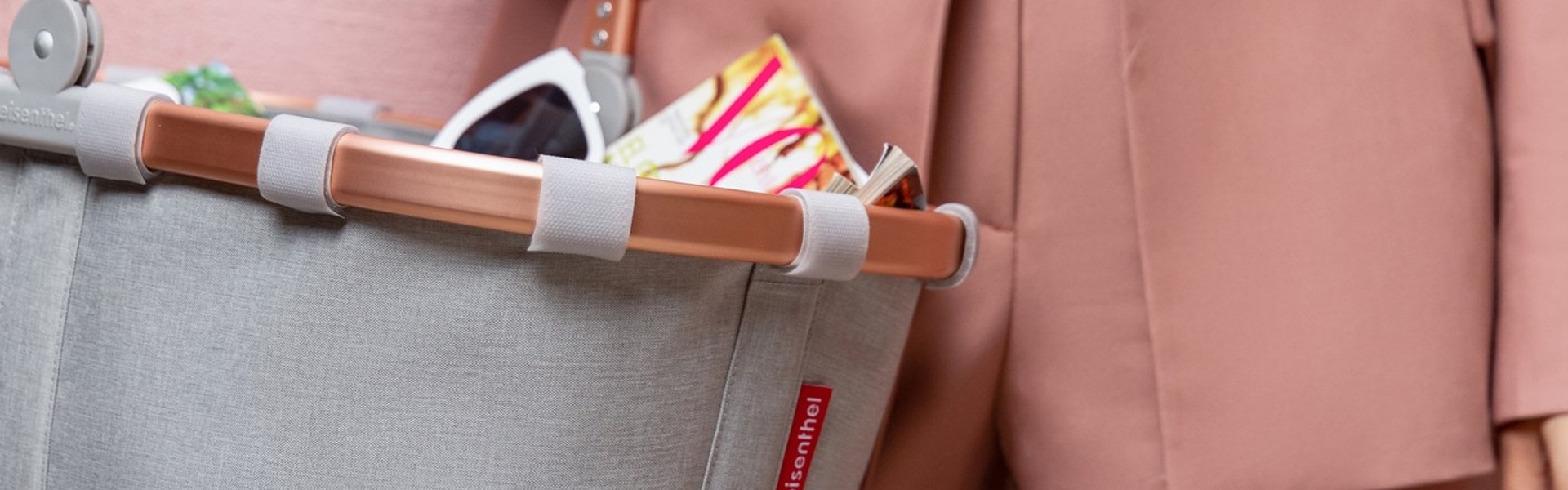 Shopping bag with sunglasses and magazine on shopping cart
